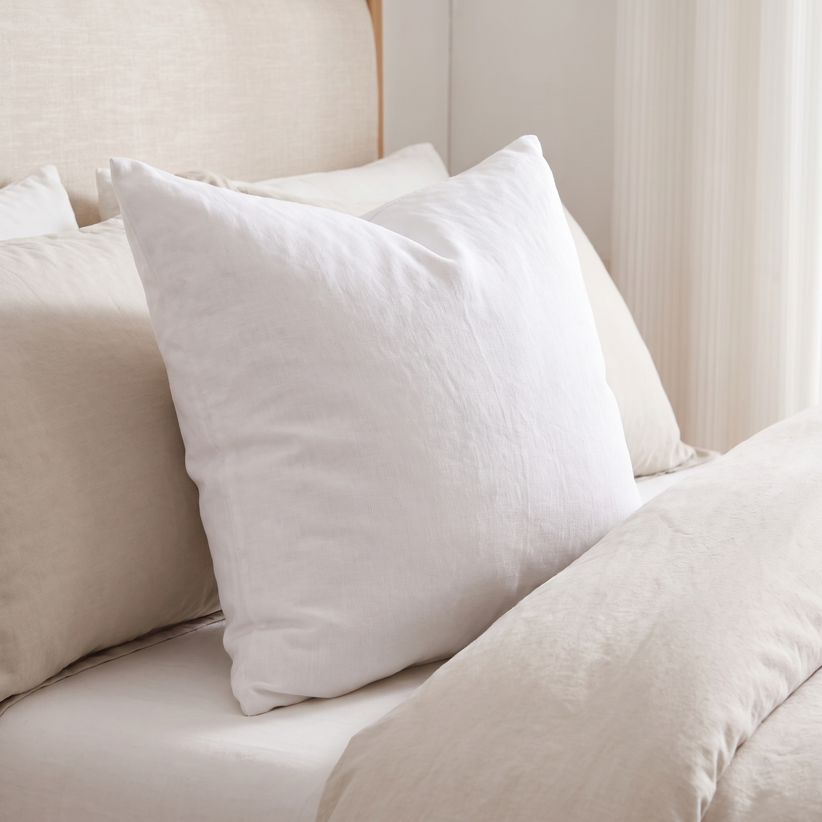 Everyday Square Cushion Insert – Soft Fill – inside a cover on a bed