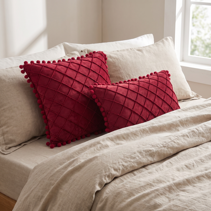 Quilted Luxe Cushion Cover with Pom Pom Trim – styled on a bed