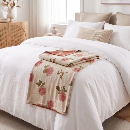 Rose Print Bamboo Cooling Blanket – folded on a bed