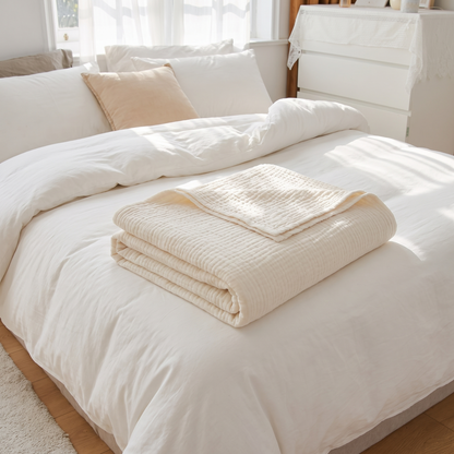 Muslin Cotton Multi-Layer Throw Blanket – folded on a bed