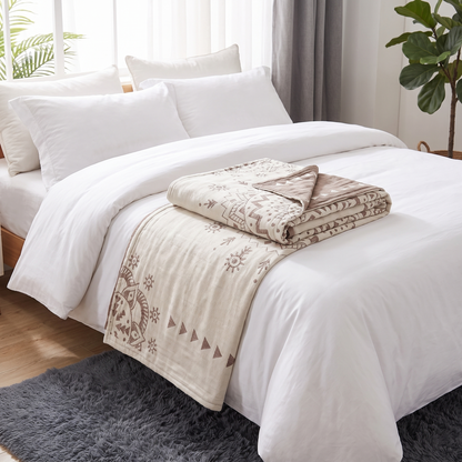 Mandala Reversible Cotton Throw Blanket – folded on a bed